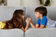 © Lisa Tichané - kids arm wrestling on couch