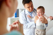 © Syda Productions - doctor or pediatrician with crying baby at clinic
