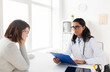 © Syda Productions - doctor with clipboard and woman patient at clinic