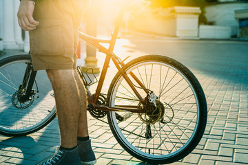 Poster - Unrecognizable Young Man With Bicycle Standing On Street At Sunrise Daily Routine Lifestyle