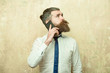© Volodymyr - bearded man or hipster with long beard speaking on phone