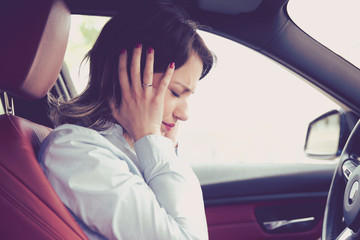 Stressed woman driver sitting inside her car