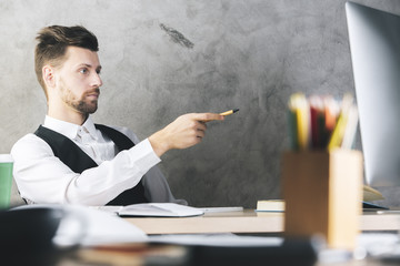 Canvas Print - White businessman pointing at computer screen