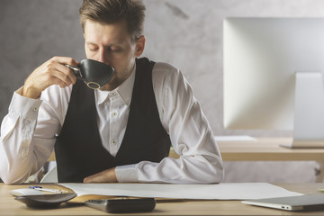 Sticker - Handsome male drinking coffee at workplace