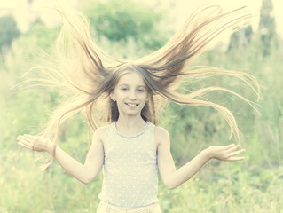 Cute teenage girl with charming smile picking daisies