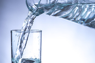 Pouring water from pitcher into a glass