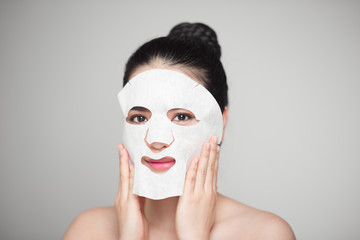 Wall Mural - Spa, healthcare. Woman with purifying mask on her face isolated on white background