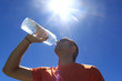 © MonikM - man drinking water with the sun over him