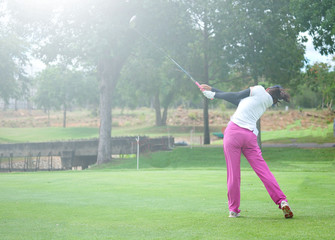 Wall Mural - Woman golf is a sport requiring heat tolerance.