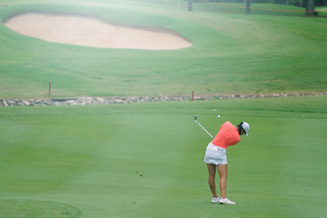 Wall Mural - Woman golf is a sport requiring heat tolerance.