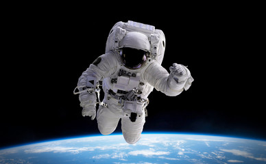 Wall Mural - astronaut in orbit of planet earth