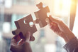 © oatawa - Woman hand connecting jigsaw puzzle on desk, Business solutions, success and strategy concept