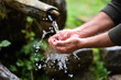 man washing hands in fresh, cold, potable water of mountain spring