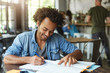 © wayhome.studio  - Attractive cheerful African American university student working on home assignment at cafeteria, writing composition or doing research, having happy enthusiastic look. People, knowledge and education