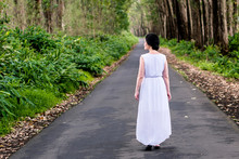 An Oriental Woman In White Dress Is Exploring In A Forest
