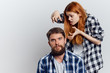 © SHOTPRIME STUDIO - Young beautiful woman and guy with beard on white isolated background, repair, building materials, tools