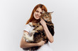 © SHOTPRIME STUDIO - Beautiful young woman on white isolated background holds a cat