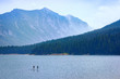 Mountain Lake Recreation. Paddle boarders drift through the Hyalite Reservoir in Montana. Majestic copy space.