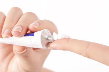 Close up image of hands with cream tube