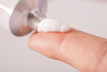 Close Up Image Of Hands With Cream Tube