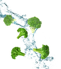 Splashing water and broccoli on white background