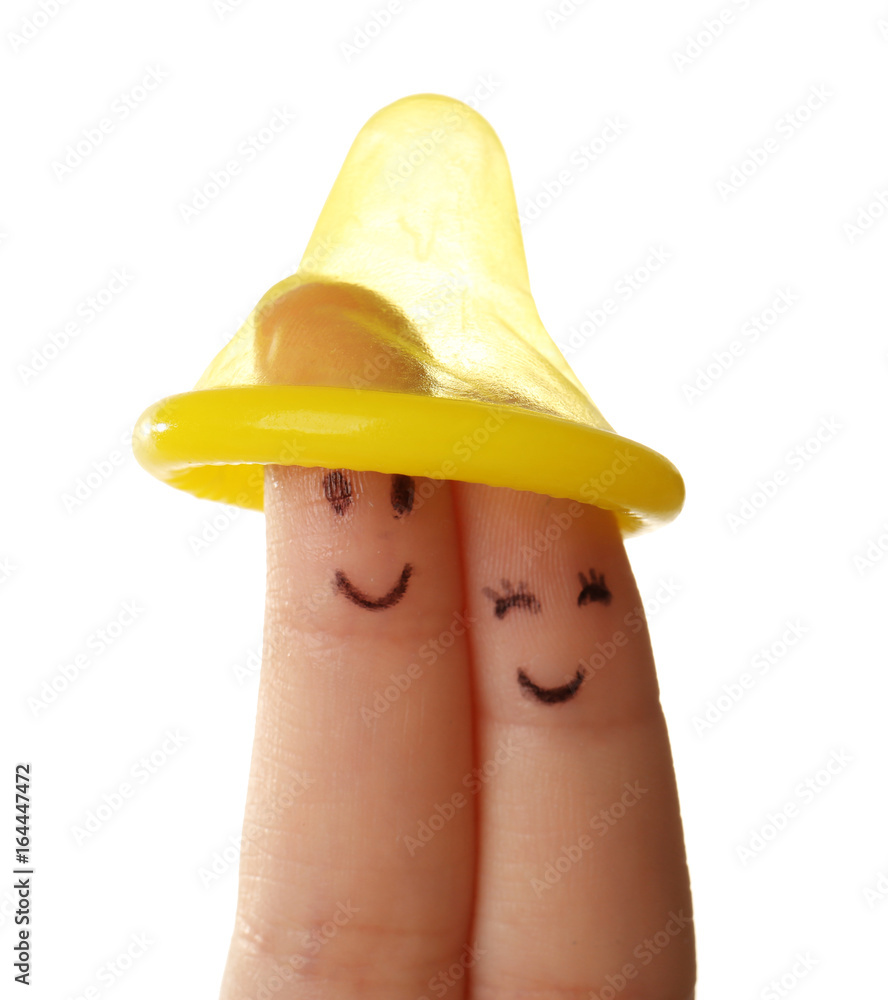 Fingers under condom. Safe sex concept