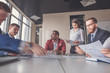 © alfa27 - Businessman sitting at table with working blurred people on background