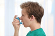 © Africa Studio - Young boy using inhaler for asthma and respiratory diseases on light background