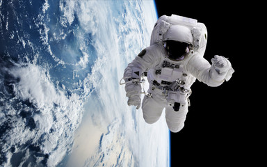 Wall Mural - an astronaut in orbit of planet earth