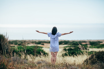 Wall Mural - Happy woman enjoy beautiful valley and sea landscape