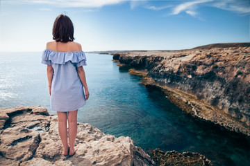 Wall Mural - Young woman enjoying beautiful sea view on Greco cape in Cyprus