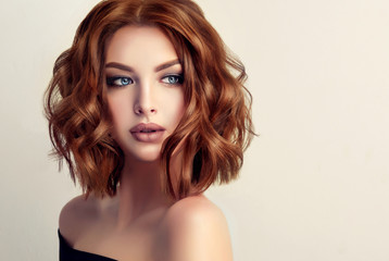 beautiful model girl with short hair .woman with red curly hair. red head .