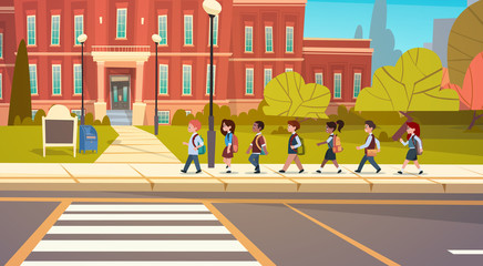 Wall Mural - Group Of Pupils Mix Race Walking To School Building Primary Schoolchildren Students Flat Vector Illustration