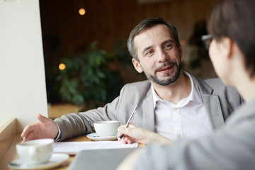 Wall Mural - Employer having talk with applicant in cafe