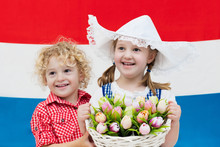 Dutch Kids With Tulip Flowers And Netherlands Flag