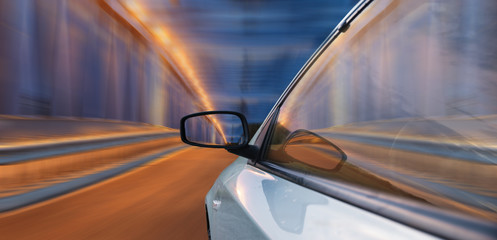 Wall Mural - A view of the cockpit of a car driving at night through an illuminated bridge