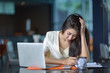 © Suntipong - Young pretty business woman with laptop in the office, smiling pretty young business woman in glasses sitting on workplace. Selective focus