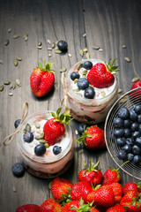 Wall Mural - delicious dessert - yogurt with strawberries and blueberries