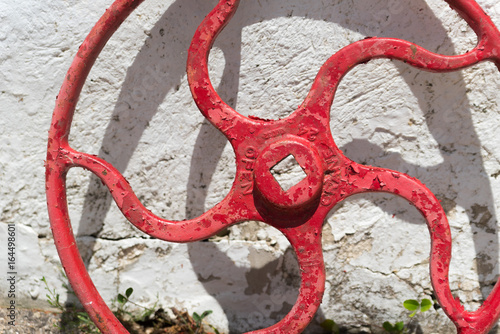 Fotografie, Obraz Big metal crane wheel standing next to a building