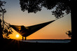 A person enjoying the sunset in a hammock