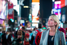 Impressed Woman In The Middle Of Times Square At Night,