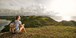 © soft_light - Hiker with backpack relaxing on top of mountain and enjoying panoramic view of coast.