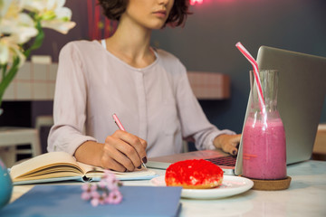 Wall Mural - Concentrated young girl writing notes