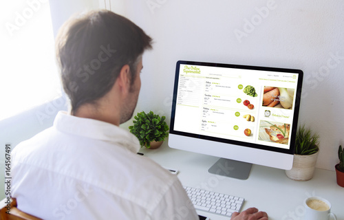 man shopping groceries online on computer Poster Mural XXL