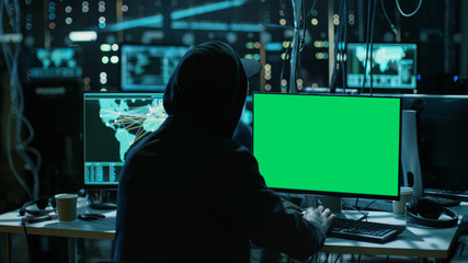 Aufkleber - Teenage Hacker is Working With his Computer with Green Screen Mock-up Display Infect Servers and Infrastructure with Malware. His Hideout is Dark, Neon Lit and Has Multiple displays.