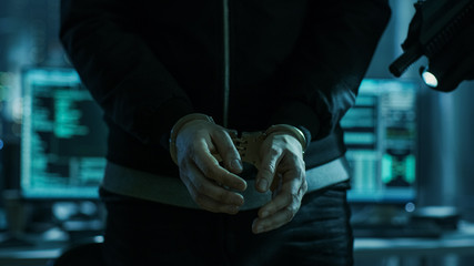 Aufkleber - Close-up of Hacker Getting Handcuffed at His Hidden Place by Cybersecurity Police Officer.