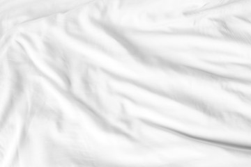 Top view of white bedding sheets after wake up in the morning