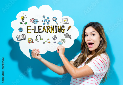 E-Learning text with young woman holding a speech bubble on a blue background Canvas Print