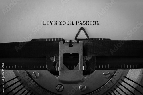 Fotografie, Obraz Text LIVE YOUR PASSION typed on retro typewriter
