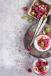 Fresh raspberry berries with yogurt or cream in glasses. Summer Breakfast Dessert Concept